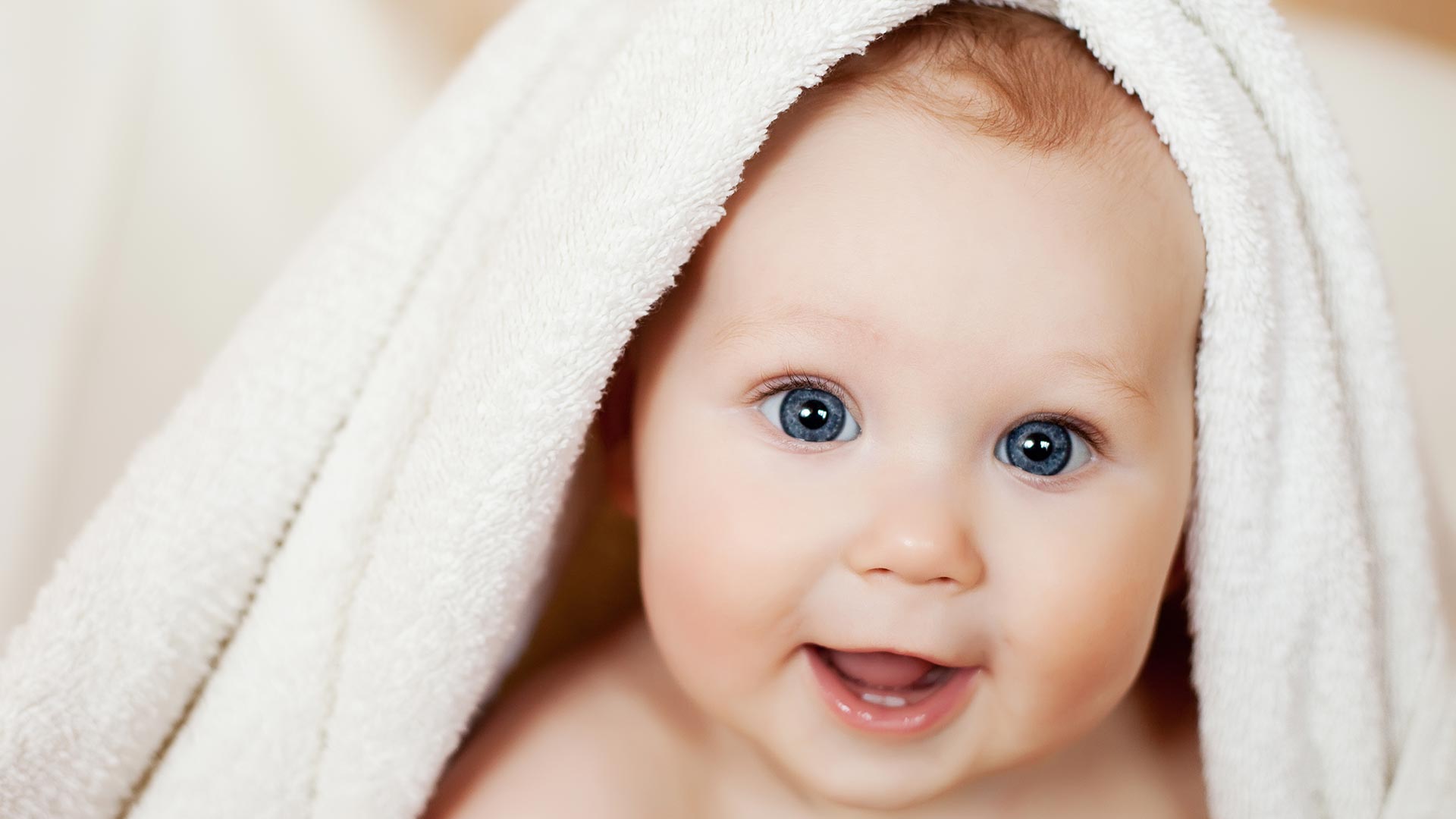 Baby with White Towel over Head
