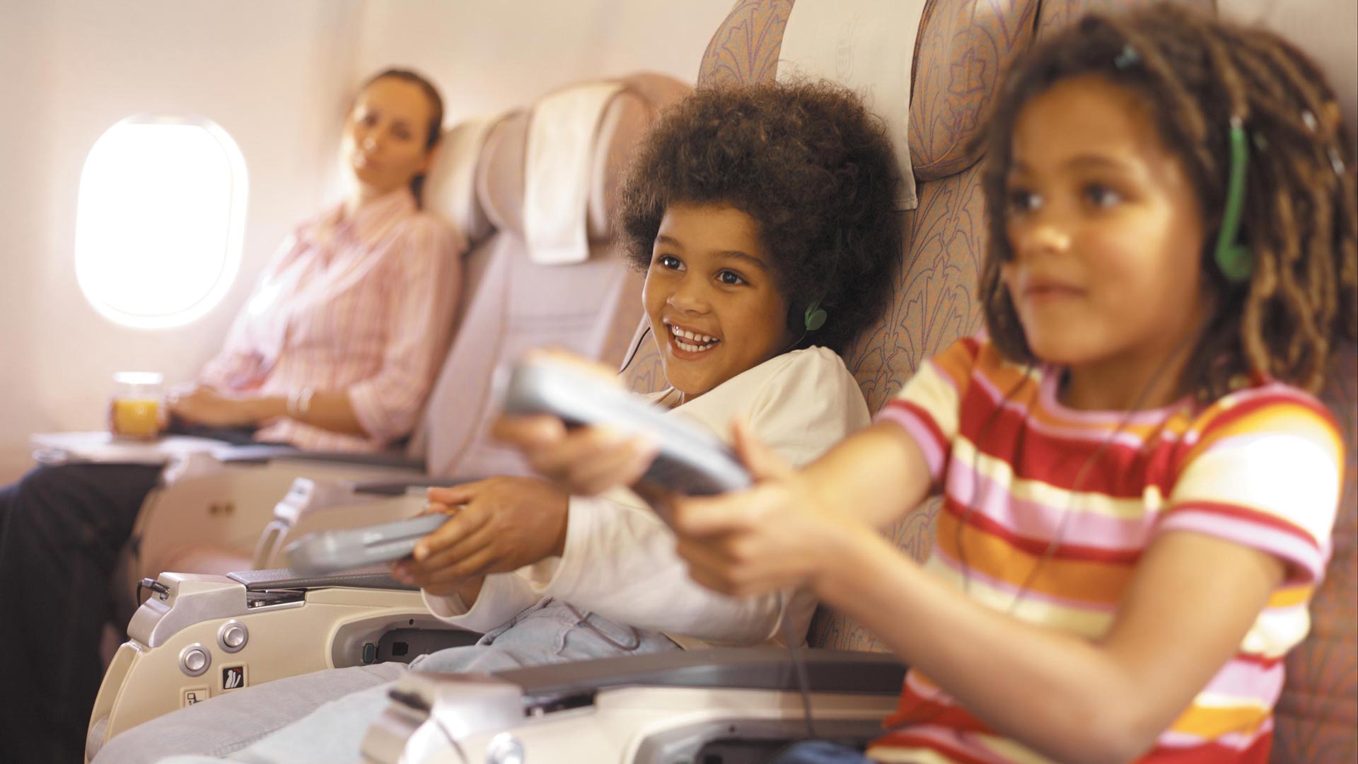 Two Kids Playing Games on Airplane